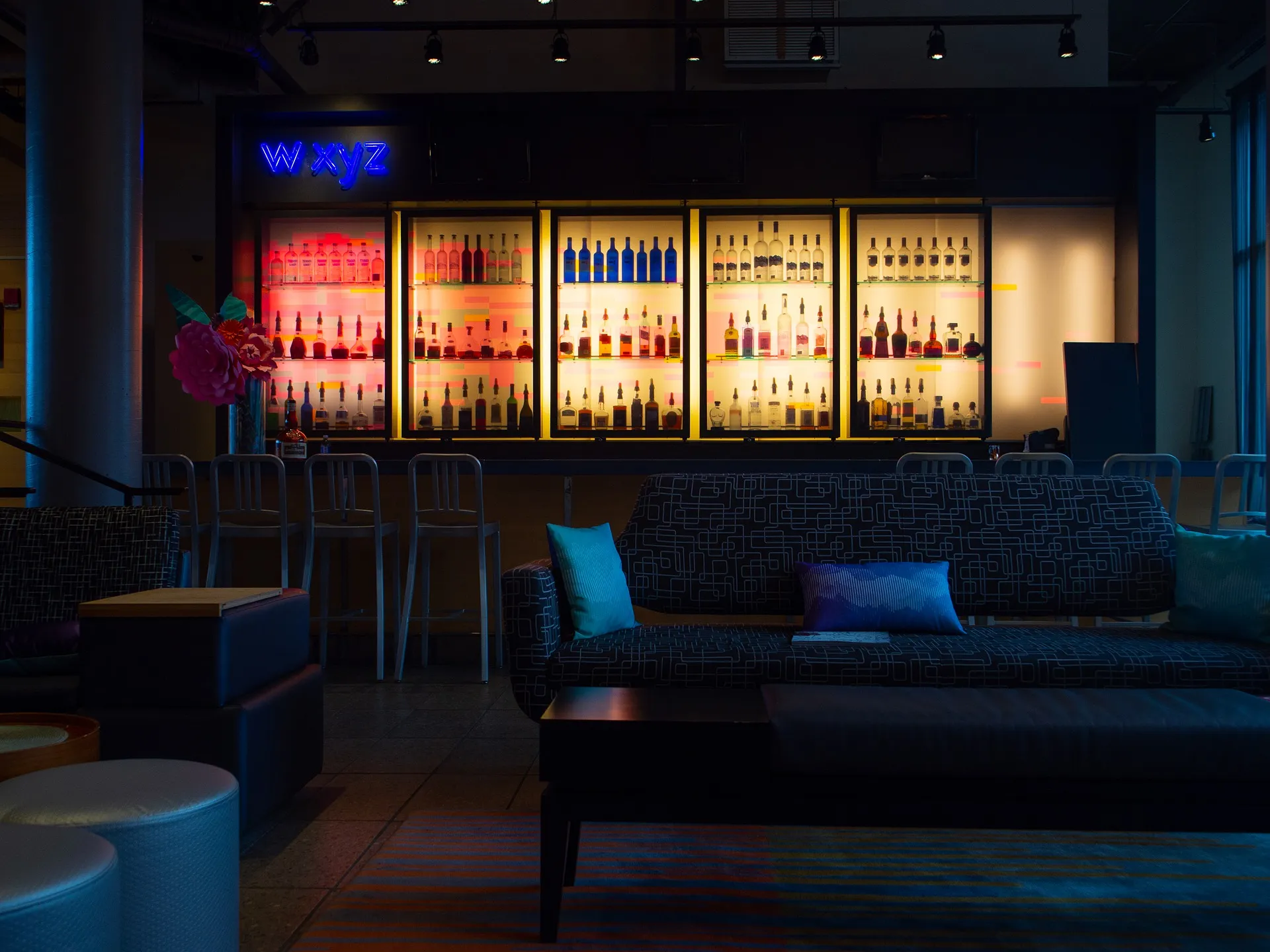 Atmospheric bar interior with illuminated back-bar shelving